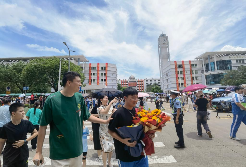 6月10日中午，家长在海口市第一中学高中部门口迎接考生。新华社记者赵叶苹 摄